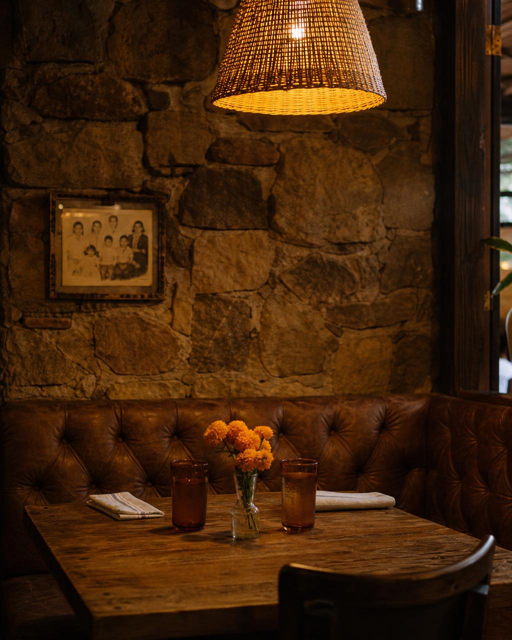 Cozy leather booth beneath a stone accent wall